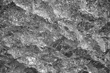 Processed collage of shiny metal silver gray foil crumpled packaging material texture