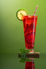 red mojito cocktails with mint leaves and lime slices  with warm background