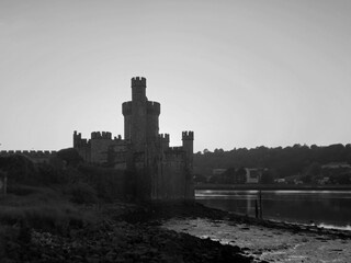 Blackrock castle observatory silhouette in the rays of sunset sun black and white monochrome background