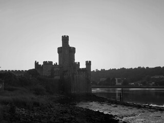 Blackrock castle observatory silhouette in the rays of sunset sun black and white monochrome background