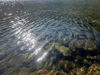 Mountain lake relaxation, pure waterscape natural background. Laying somewhere in the mountains