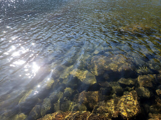 Mountain lake relaxation, pure waterscape natural background. Laying somewhere in the mountains