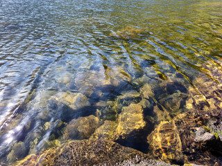 Mountain lake relaxation, pure waterscape natural background. Laying somewhere in the mountains