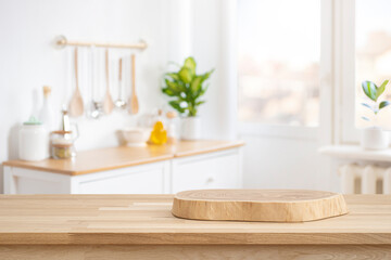 Podium or cutting board on wooden table on defocused rustic kitchen bench interior background