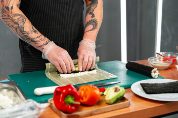 Preparing sushi rolls with fresh ingredients at a culinary studio