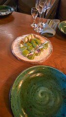 Interior in a city restaurant. Preparation for a buffet. Dishes and food