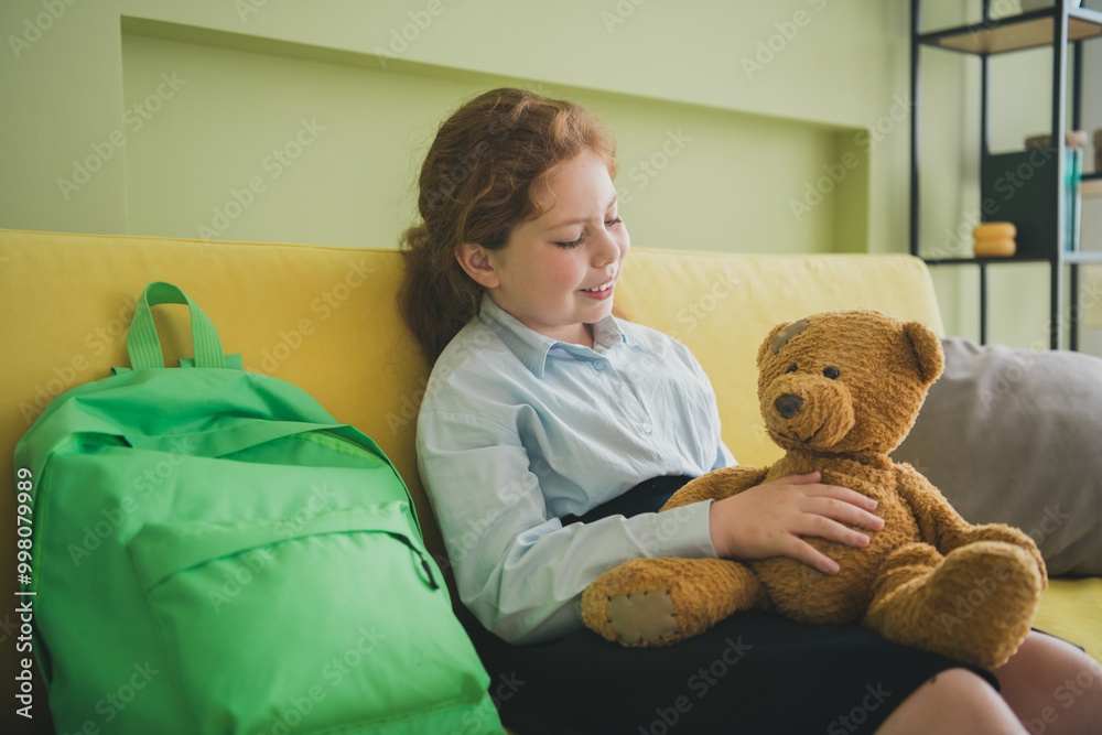 Canvas Prints Photo of cheerful cute adorable small girl sitting sofa hold her best friend soft toy teddy bear room apartment indoors