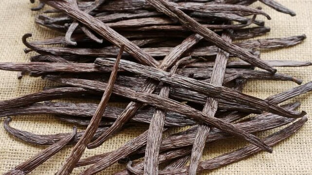 Slow motion, falling vanilla beans or pods