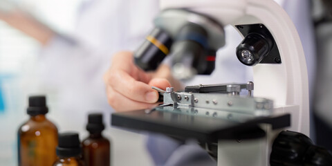 Close up on Scientist Conducting Precision Analysis with Laboratory Microscope