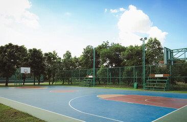 Outdoor basketball court in public park. Urban sport. Sunny day activity.
