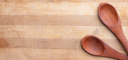 Panorama style picture of wooden spoons on a chopping board 