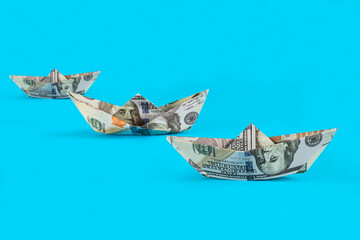 One hundred paper boat money US dollar bills. American cash usd dollars banknotes