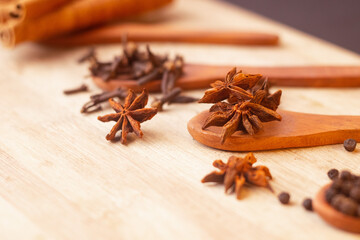 anise star spice for baking in wooden spoon on wooden table