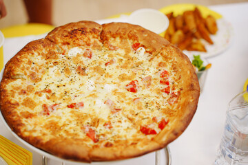 pizza margherita on the holiday table. A simple and delicious dish of Italian cuisine.