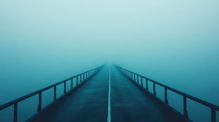 Misty road disappearing into fog, creating a serene and mysterious atmosphere.