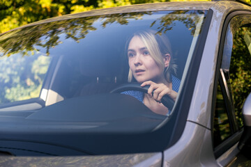 Stressed woman drive car feeling sad and shocked. Caucasian blond girl tired and feeling frustrated. 