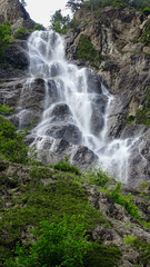 Obraz premium The white cascade waterfall like a white long hair, Austrian Alps, June 27, 2018