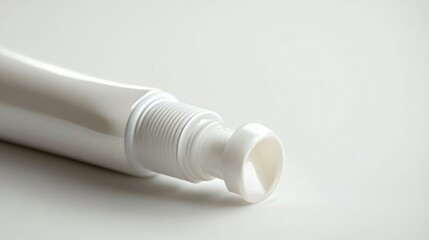 A tube of toothpaste with the cap open, isolated on a white background