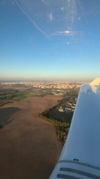 View of the city from the airplane cockpit, private flight. Aeroclub. Vertical video. 