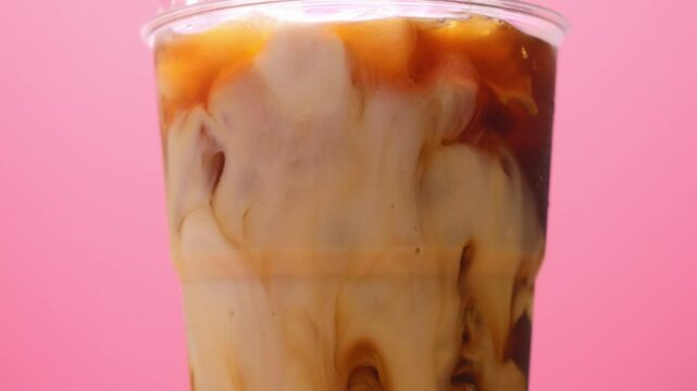Close-up SLO MO, Fresh milk mixed with fresh Americano, Concept coffee art.