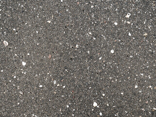Black micro stones and sea shells sand beach as a background
