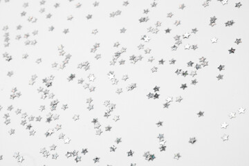 sparkles silver stars on white background with text place- Image