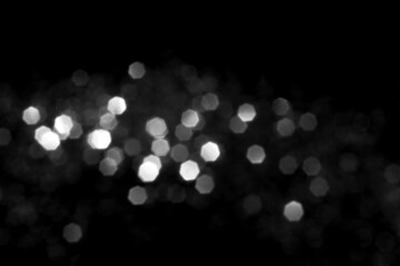 White gray blurred bokeh lights on black background. Glitter sparkle stars for celebrate. Overlay for your design