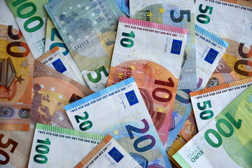 Many european euro money bills in chaotic arrangement. Pile of eur banknotes with different colors and condition