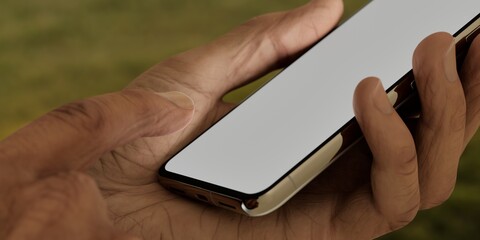 Asian old male using smartphone with a blank white screen. Backyard, gathering, sunset apps mockup. Vertical phone orientation