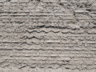 Wheel tread marks in the sand. Heavy machinery. Sand quarry, road construction. Aerial view.