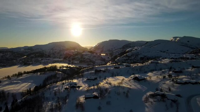 Drone shot over Sirdal Agder Norway at winter with blue skies and low sun