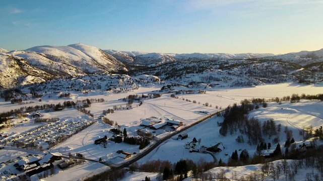 Drone shot over Sirdal Agder Norway at winter with blue skies and low sun
