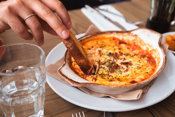 Delicious italian provolone baked with tomato sauce and oregano with slices of toast bread.