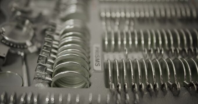 Close-up view of precision optical lenses and prisms in monocolor, highlighting shapes and materials used in optic technology. Precision Optics and Lenses Equipment in Detailed Monochrome