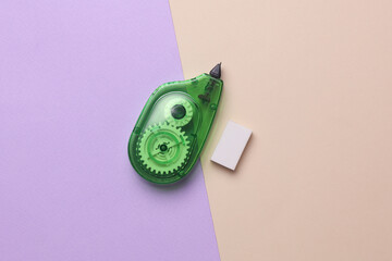 Corrector and eraser on a pastel background.