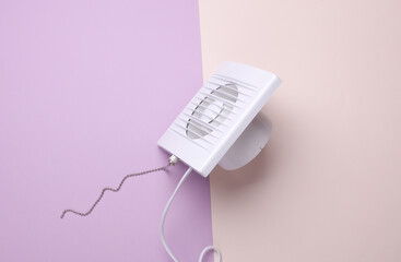 Ventilation hood fan on pastel background.