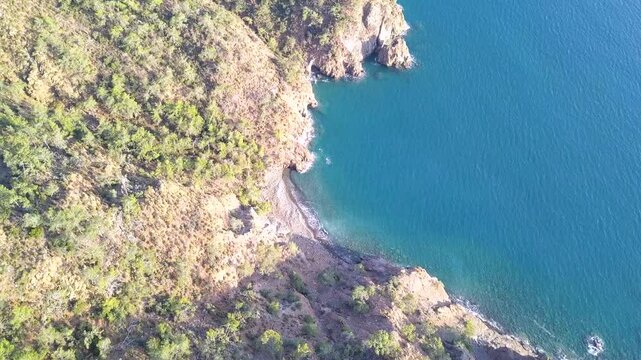 Drone view of a small hidden beach only accessible by boat in Fethiye Turkey