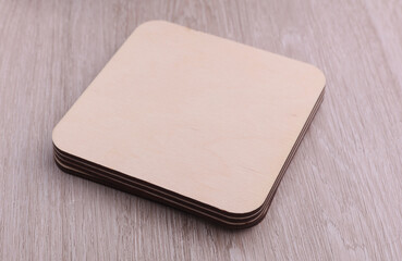 Wooden square drink coasters on the table