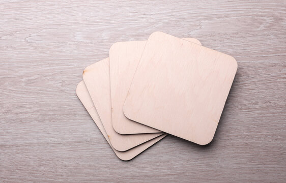 Wooden square drink coasters on the table