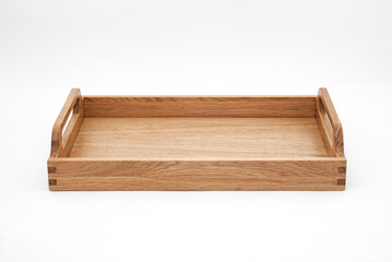Elegant solid oak wood tray with dovetail joints and carved handles on the sides for easy carrying on white background