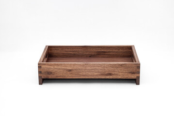 Solid walnut wood tray with dovetail joints and cutout handles on the sides for easy carrying on white background