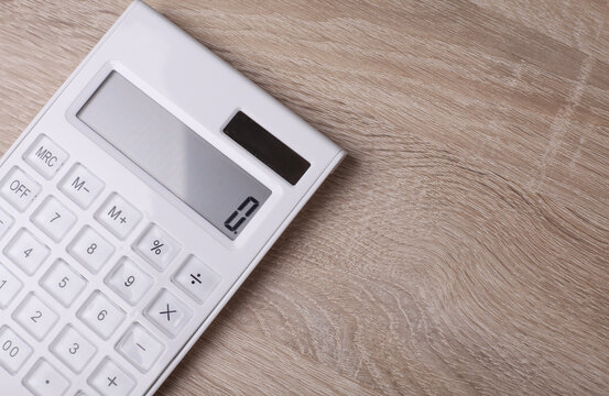 White plastic calculator on table close up