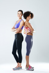 Fitness, women and portrait with arms crossed in studio for training, teamwork and support in exercise. Happy, friends and athlete with smile by white background for sports, gym and workout together