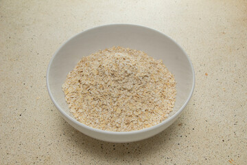 a bowl of still-dry oatmeal sat on the clean granite counter