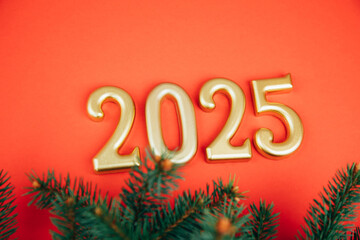 Greeting Christmas, new year's background. Golden figures, numbers 2025 on a red background with pine branches. Top view