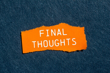 Final thoughts message written on ripped torn orange paper piece with gray felt background....