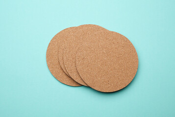 Cork coasters for drinks on a blue background