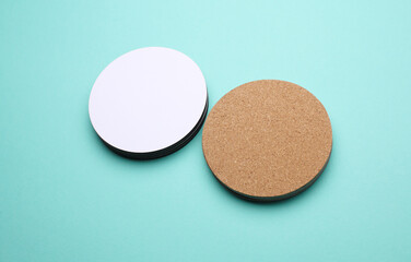 Cork and white coasters for drinks on blue background