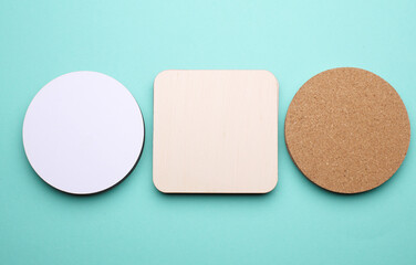 Cork, white, wooden coasters for drinks on a blue background