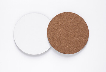 Cork and white coasters for drinks on white background